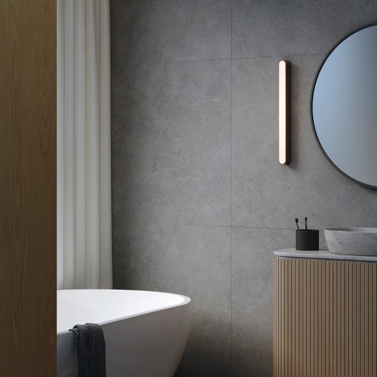 Astro Lighting Atticus 900 mirror light mounted vertically beside a bathroom mirror